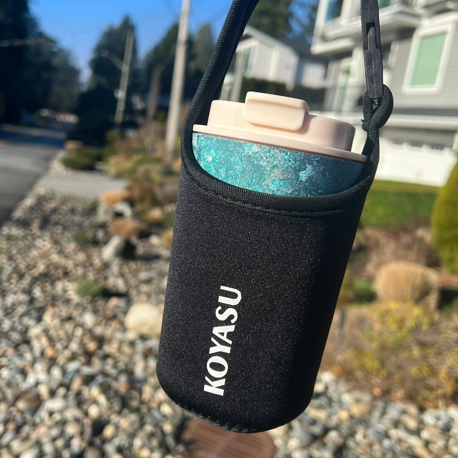 KOYASU Ti-Zen Blue Titanium Travel Mug in protective sleeve pouch hanging outdoor for hiking and walking