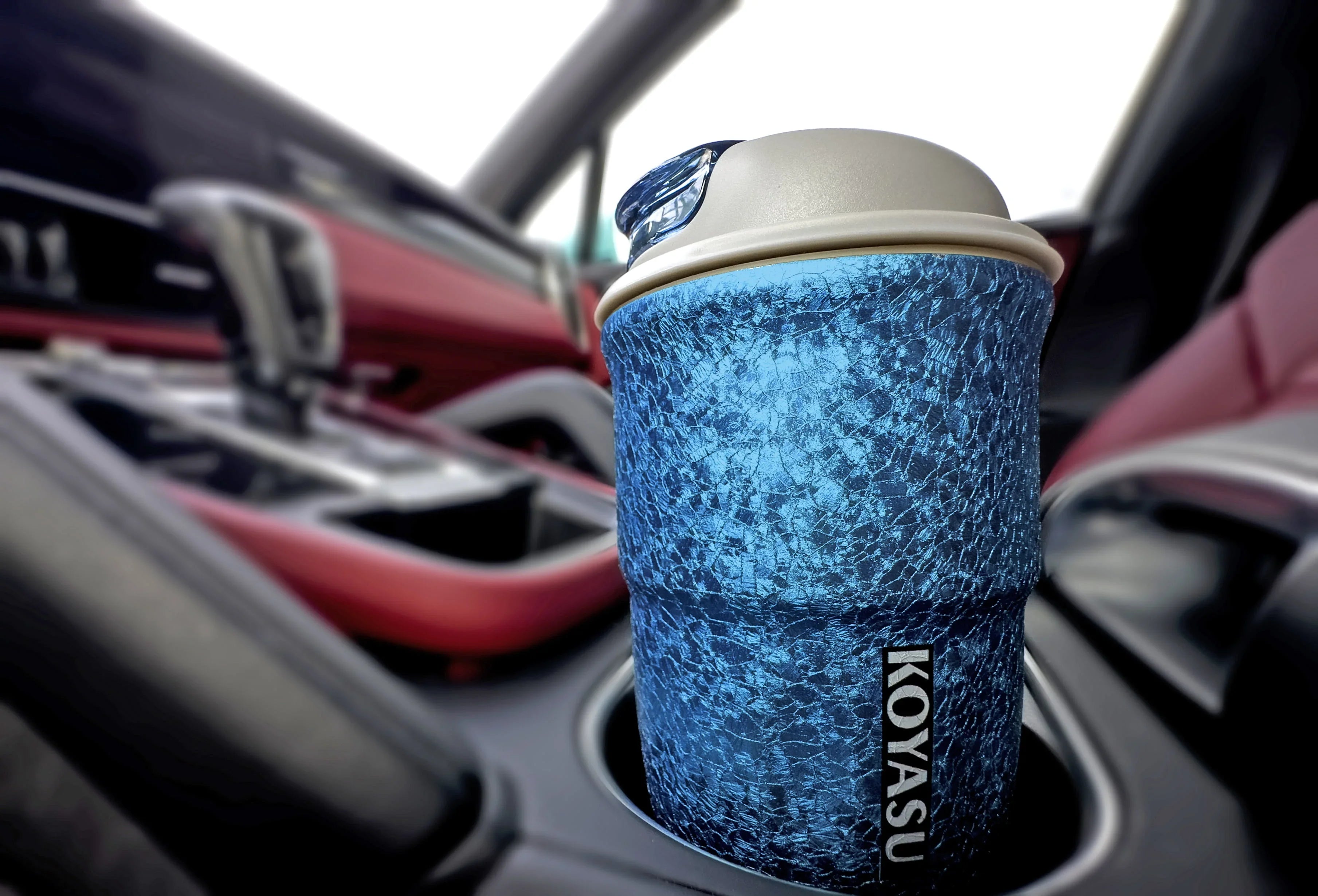 KOYASU 12oz mug in blue fits perfectly inside a luxury car cupholder.