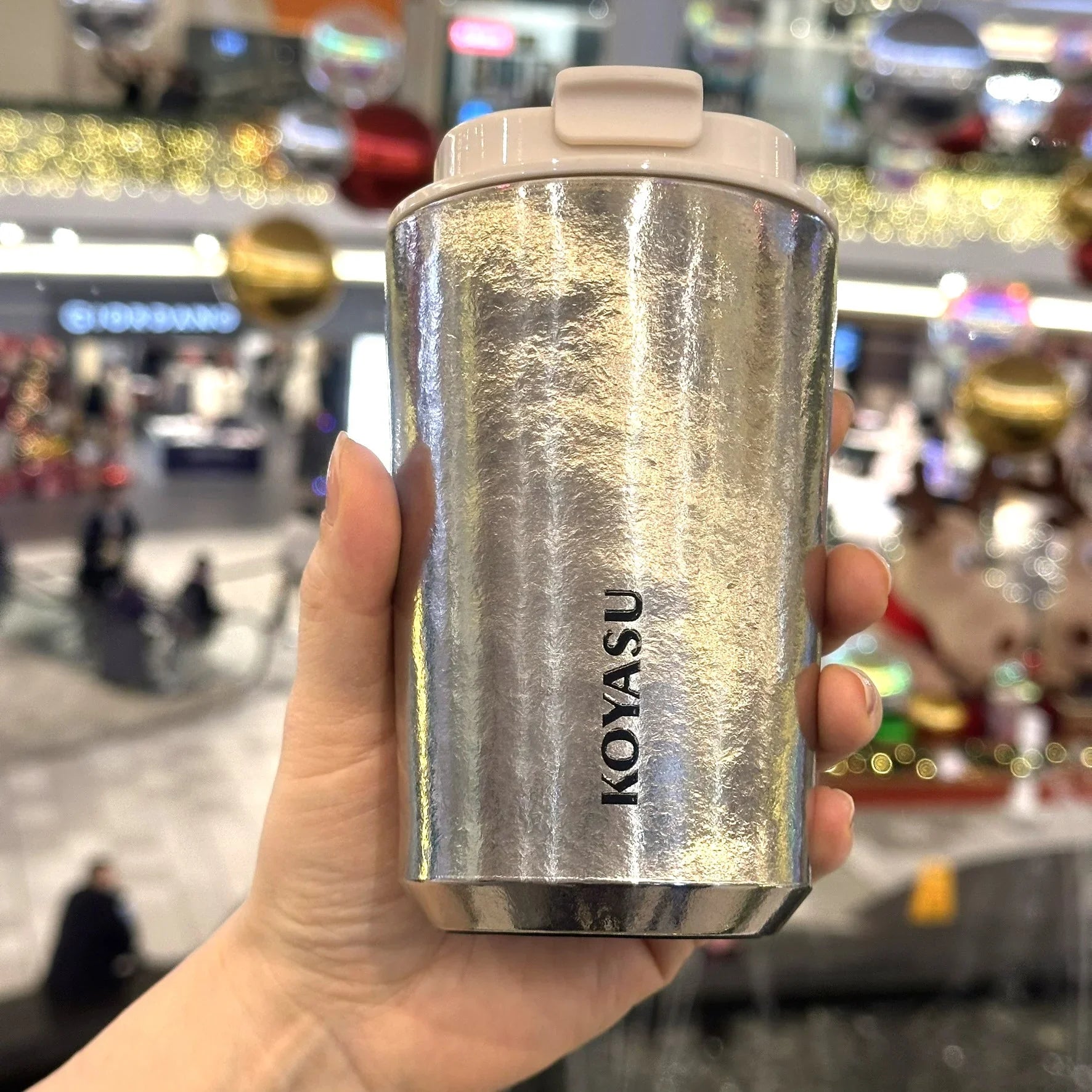 KOYASU Ti-Zen Crystal Silver Titanium Travel Mug handheld in shopping mall lifestyle
