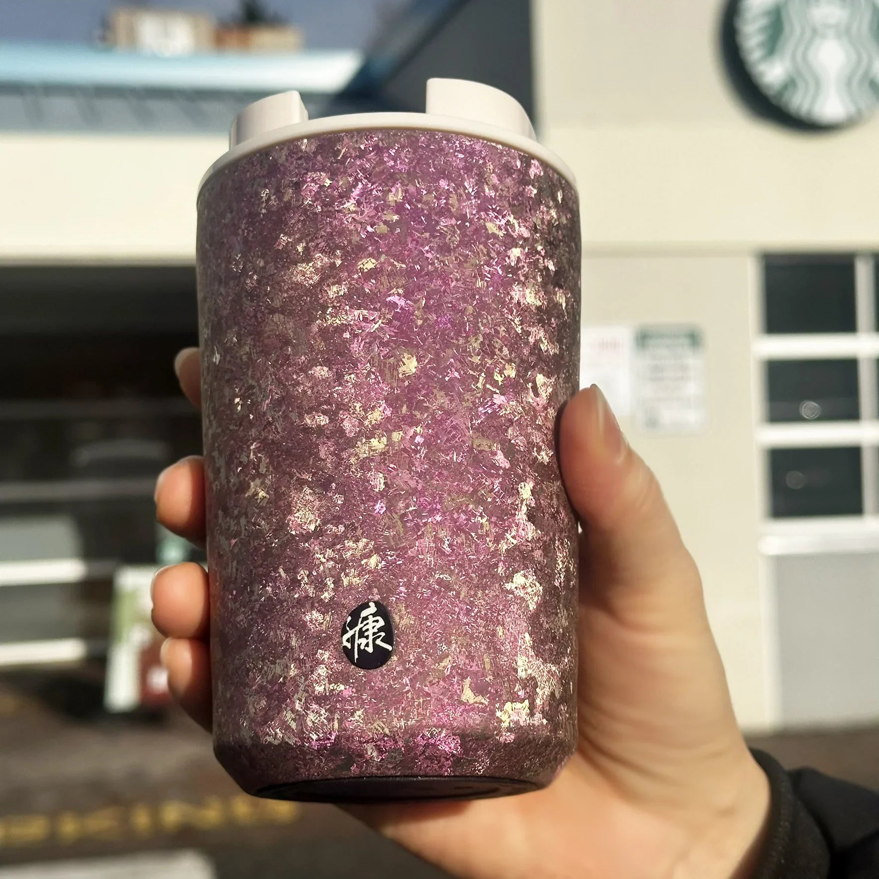 Holding KOYASU Ti-Zen Pink Titanium Tumbler outside coffee shop reusable eco friendly cup