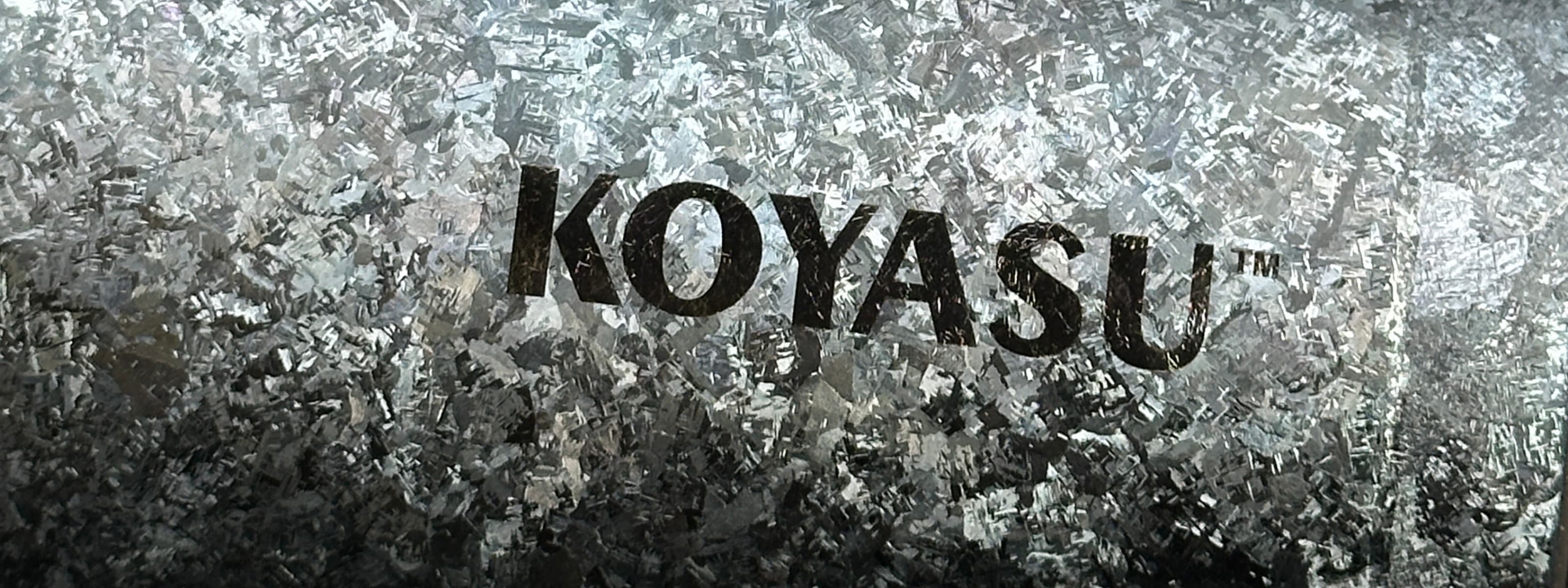 KOYASU brand logo on pure crystalized titanium surface - premium health-safe titanium drinkware.